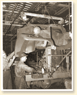 Des travailleurs montent un camion militaire dans une usine de la compagnie Ford du Canada Limite  Windsor (Ont.), novembre 1940. - Photo : Office national du film