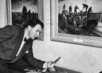 Former Australian war artist Alan Moore at an exhibition of his Belsen paintings taken in Melbourne, Victoria, 1947, donated by the artist to the collection of the Australian War Memorial P00927.002