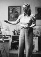 An informal portrait of the artist Sheila Hawkins (later Bowden), painting at her easel in her studio; taken in Hampstead, London, England. c. 1944; donated by the artist to the collection of the Australian war Memorial P02253.002