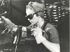 Ethel Mitchell doing light welding on a Bren Gun magazine. Like other welders, she took a two-week high school course in welding torch technique before coming to work nine months ago. Note safety goggles and arm guard. National Film Board of Canada. Photothque / Library and Archives Canada / C-075211