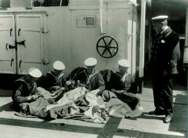 Marins du NCSM Niobe en train de coudre des pavillons 