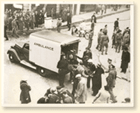 Casualties are placed in an ambulance by Air Raid Precautions workers, after a German bombing raid on a town in East Anglia, England, 1940. Photo Credit: Acme Newspictures Inc. Photo, CWM Reference Photo Collection