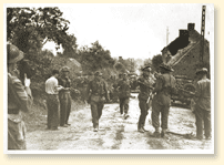 D-Day and the Normandy Invasion - German troops surrendering to the South Alberta Regiment at St-Lambert-sur-Dives in the 'Falaise Pocket', August 1944.  Major D.V. Currie, on the left with a pistol in hand, won the Victoria Cross, the highest combat decoration in the British Commonwealth, for his leadership in these operations. Canadian Military Photograph, No 38879, CWM Reference Photo Collection