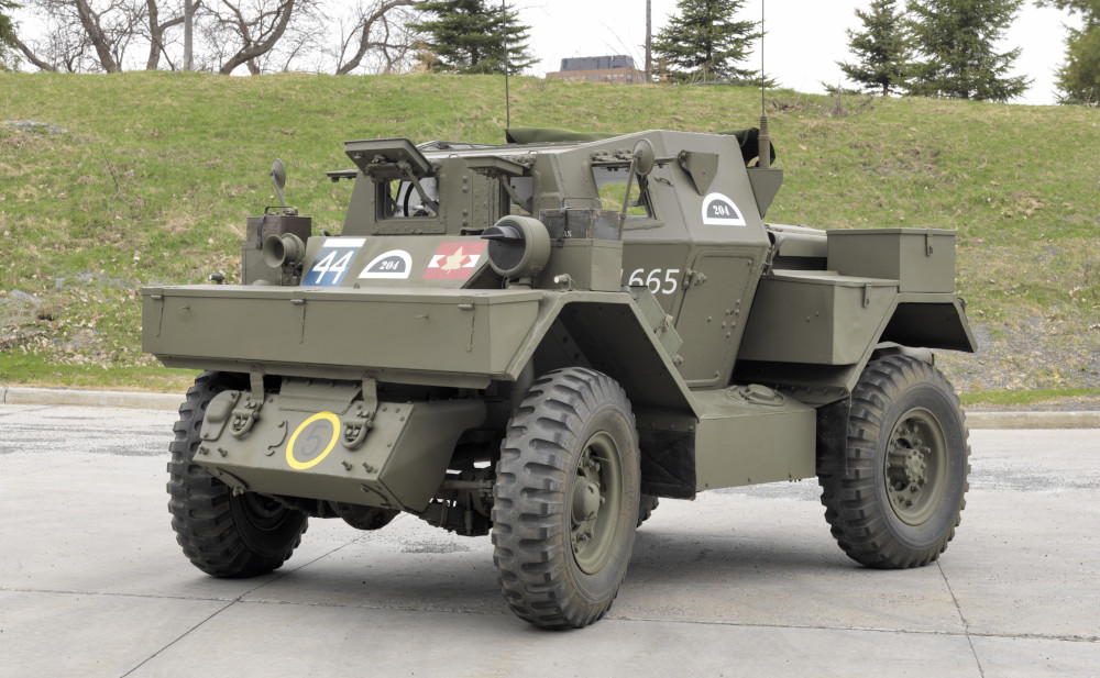 A small, green armoured vehicle with wheels and numerous radio antennas.