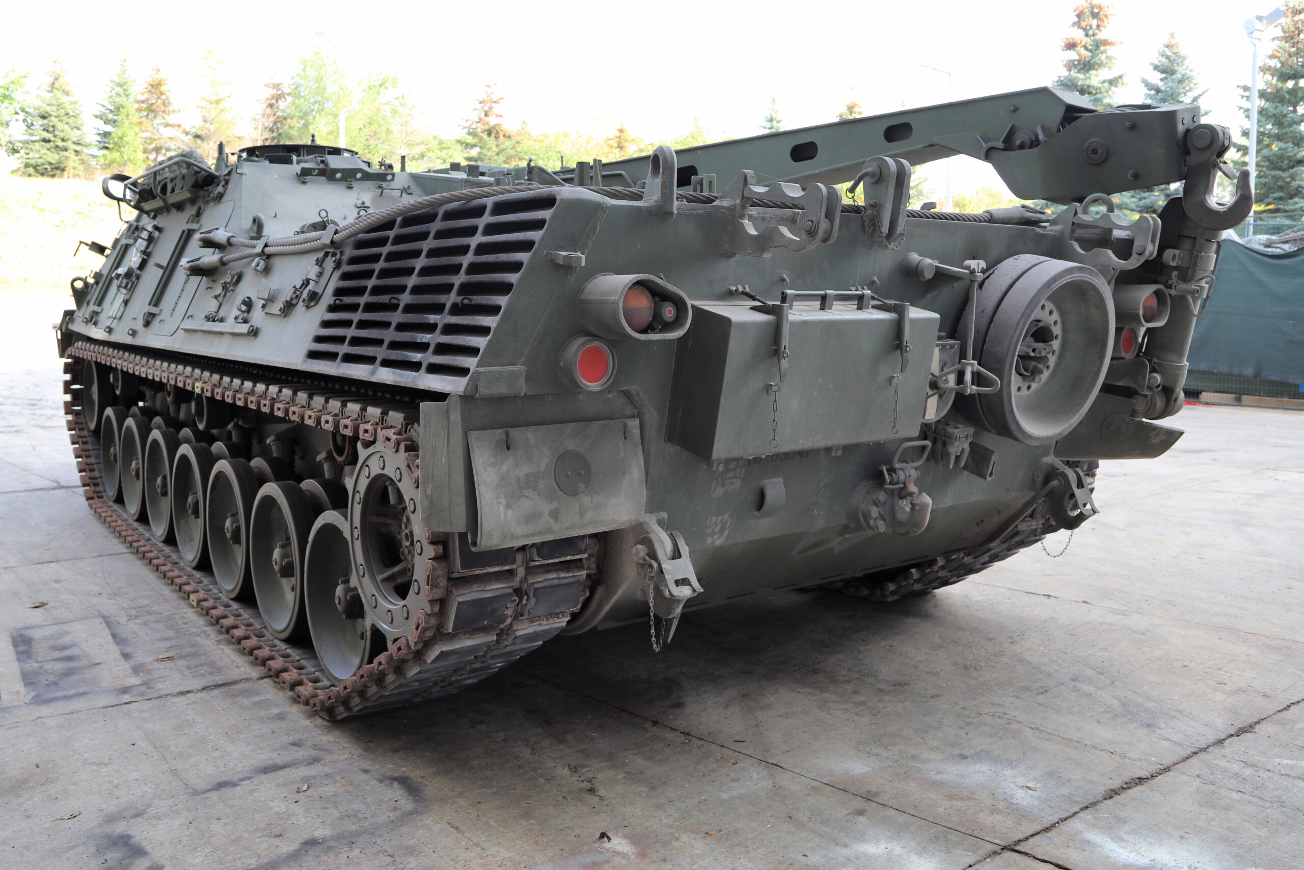 A long, tracked armoured vehicle with a large folded-down metal structure on top.