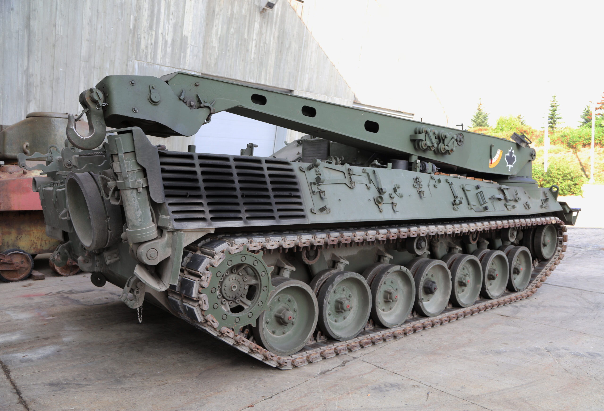 A long, tracked armoured vehicle with a large folded-down metal structure on top.